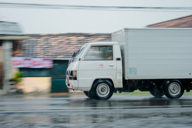 Moving truck transporting household goods and moving boxes to a new location